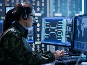 Women in military uniform on computer